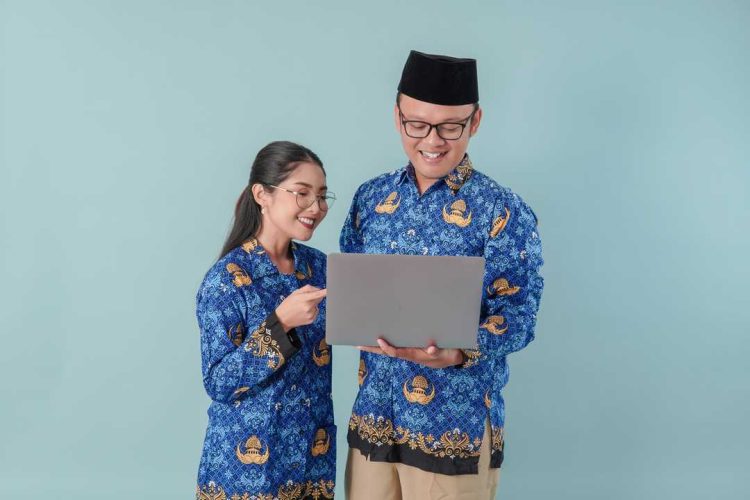 happy-indonesian-government-workers-wearing-blue-batik-uniform-holding-pointing-laptop-1.jpg